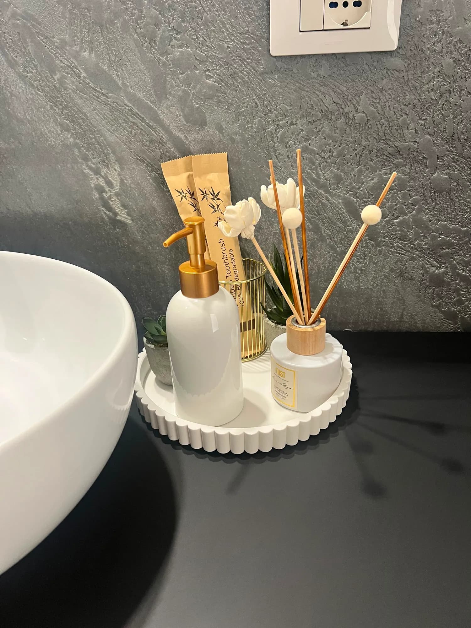 Vassoio con dispenser di sapone, spazzolini in bambù e diffusore di profumo nel bagno del Glam Turin Apartment